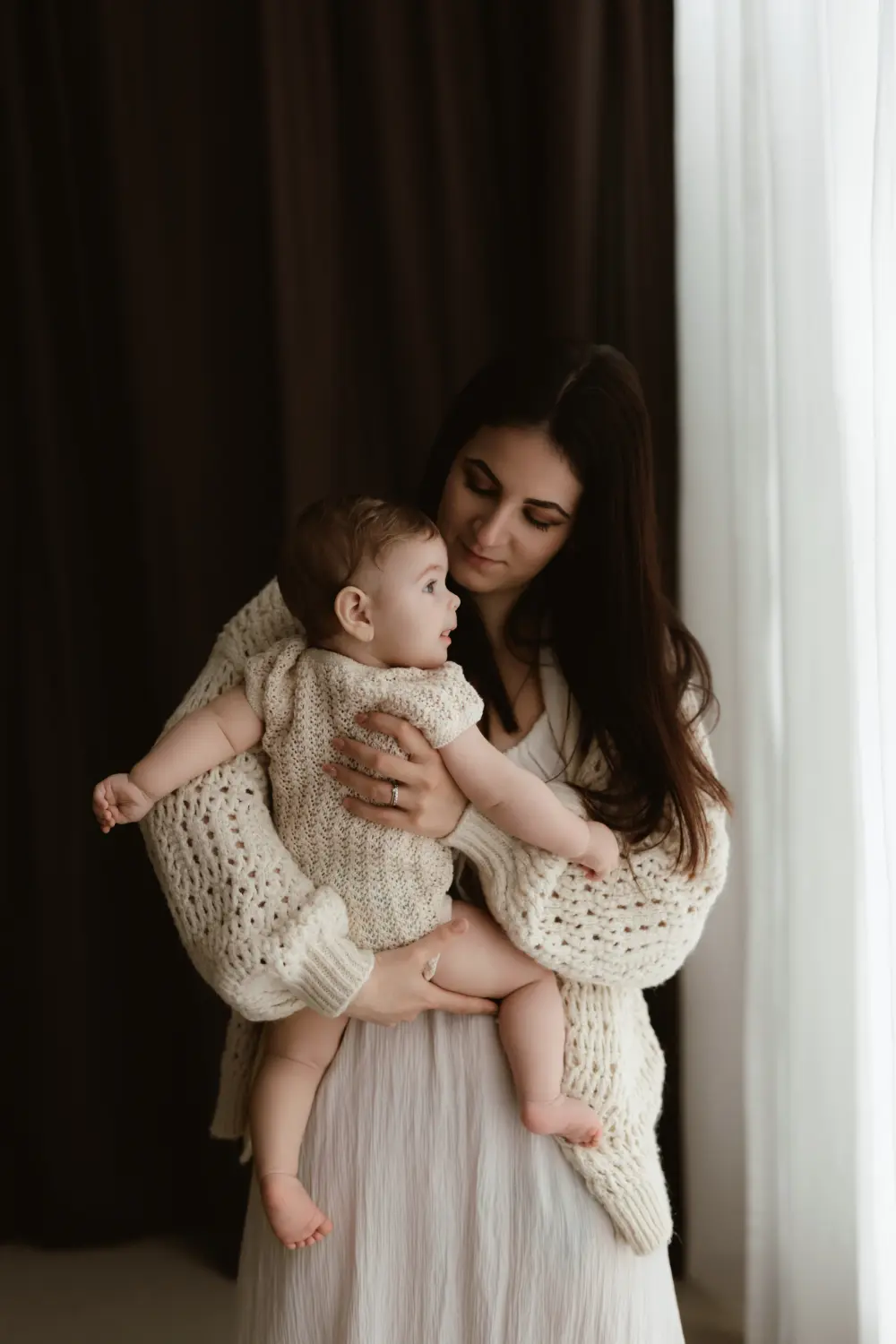  Mama sa láskavo pozerá na bábätko počas prirodzeného materského fotenia v ateliéri v Nitre a okolí 